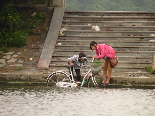 Cleaning a bike in the river