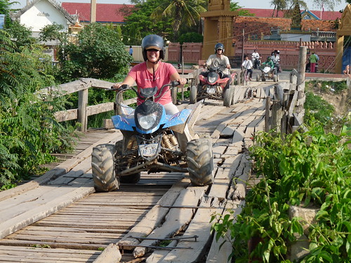Claire crossing a rickety bridge on the quad bike tour110624